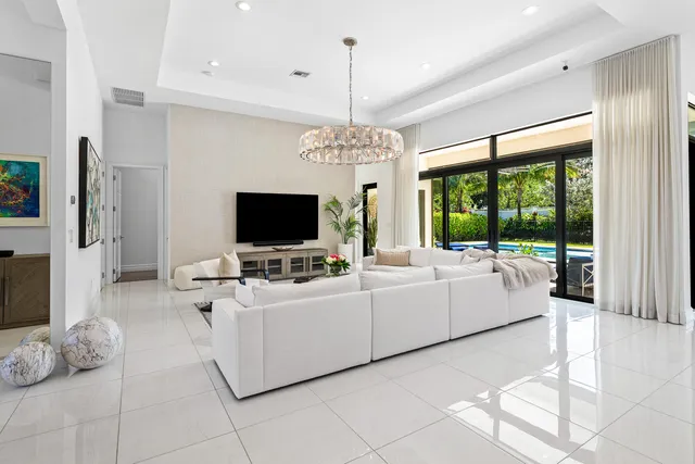 a dining room with furniture a chandelier and a rug