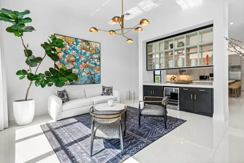 a bedroom with a bed tv and a large window