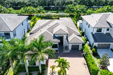 a aerial view of a house with a yard and potted plants