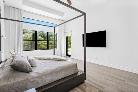 a bedroom with a bed and glass window
