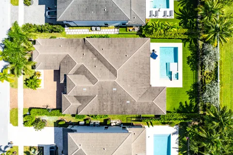 a view of a swimming pool with palm trees