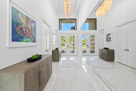 a dining room with stainless steel appliances a table chairs and a kitchen view