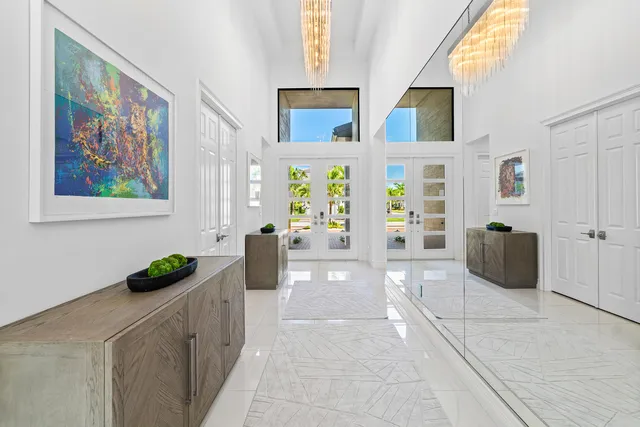 a dining room with stainless steel appliances a table chairs and a kitchen view