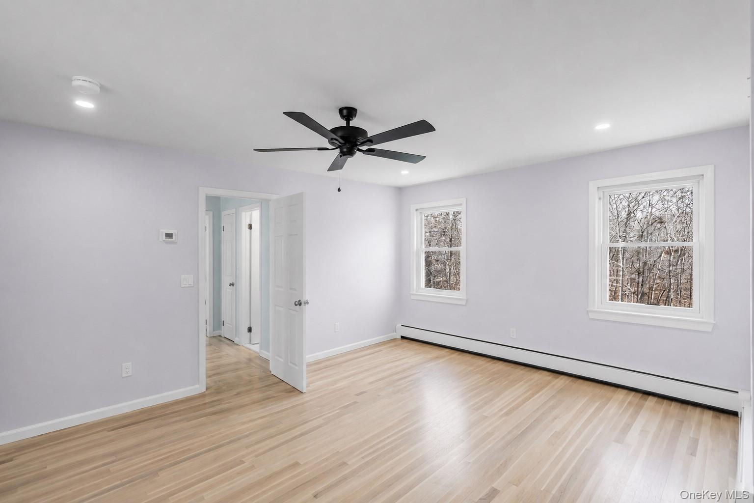 5845 North Bayview Road Southold, NY 11971 - Photo 20 of 26 Expansive second floor bedroom with large windows and hardwood flooring