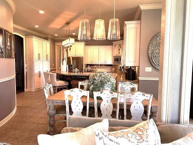 a living room with furniture fireplace and large windows