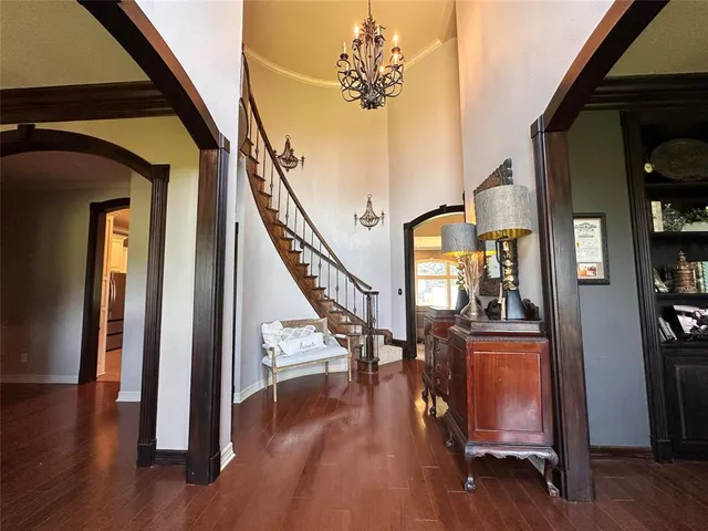 a view of an entryway with wooden floor and door