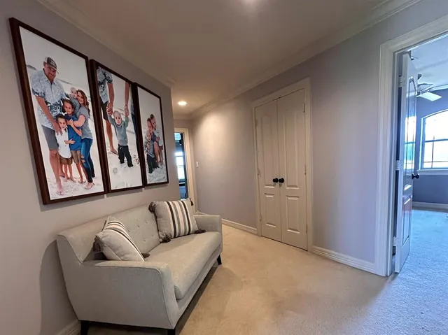 a hallway with a couch and painting on the wall