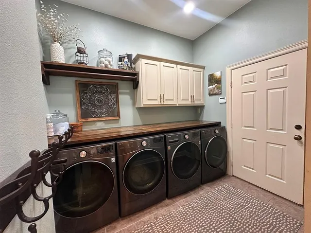 a utility room with sink dryer and washer