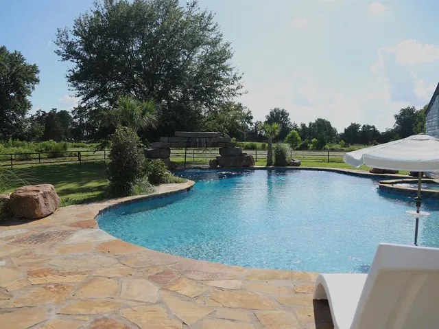a view of a swimming pool with a lake view
