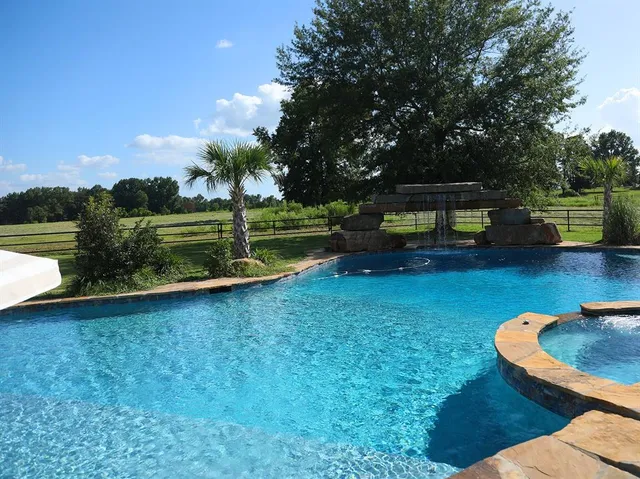 a view of a backyard with swimming pool