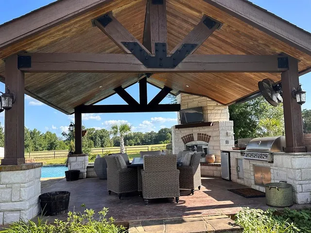 a view of a patio with table and chairs potted plants with wooden floor and fence