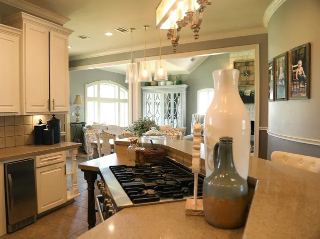 a kitchen with a stove a sink and cabinets
