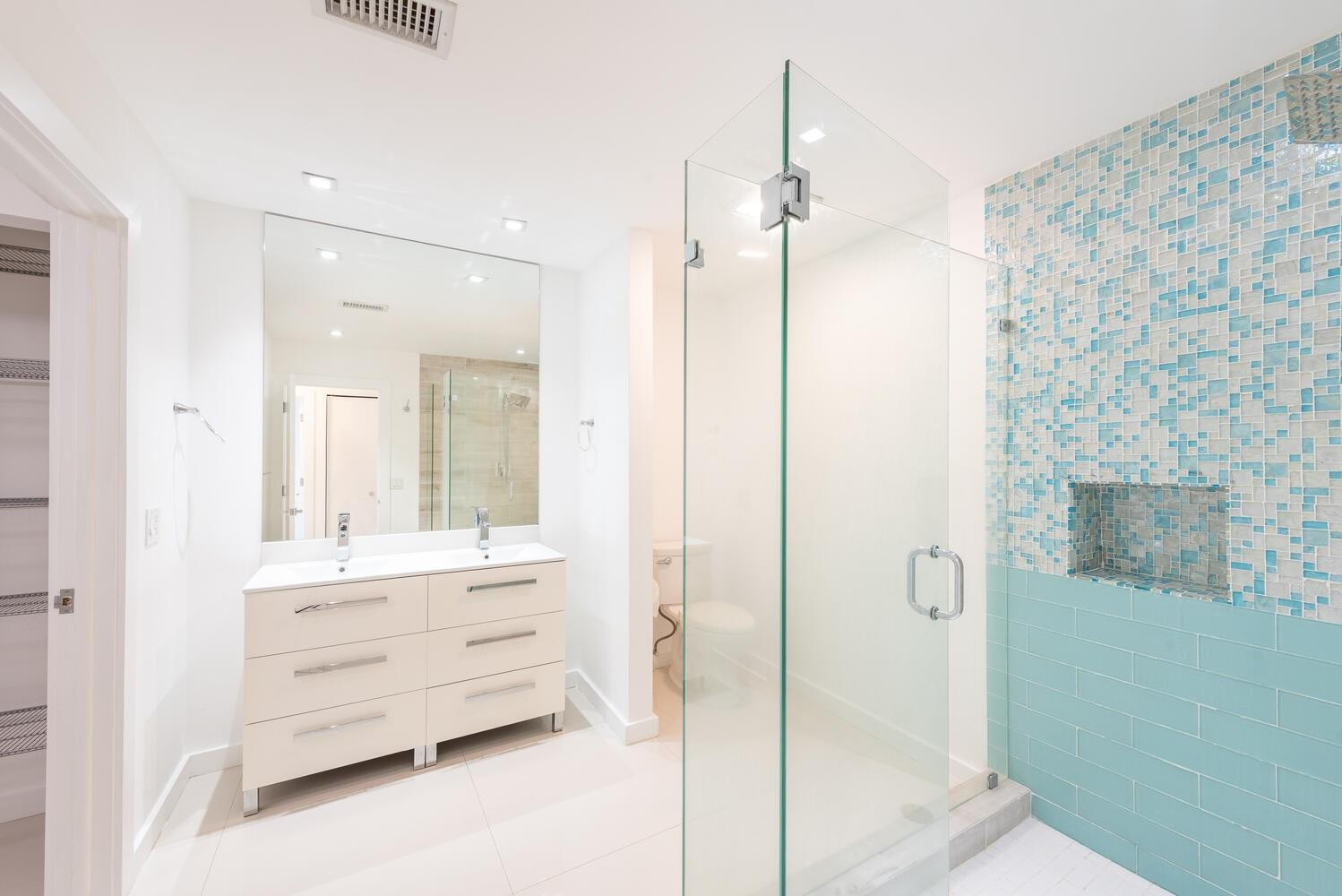 6604 Southwest 114th Place, Unit C72 Miami, FL 33173 - Photo 17 of 28 a bathroom with a double vanity sink a mirror and a shower