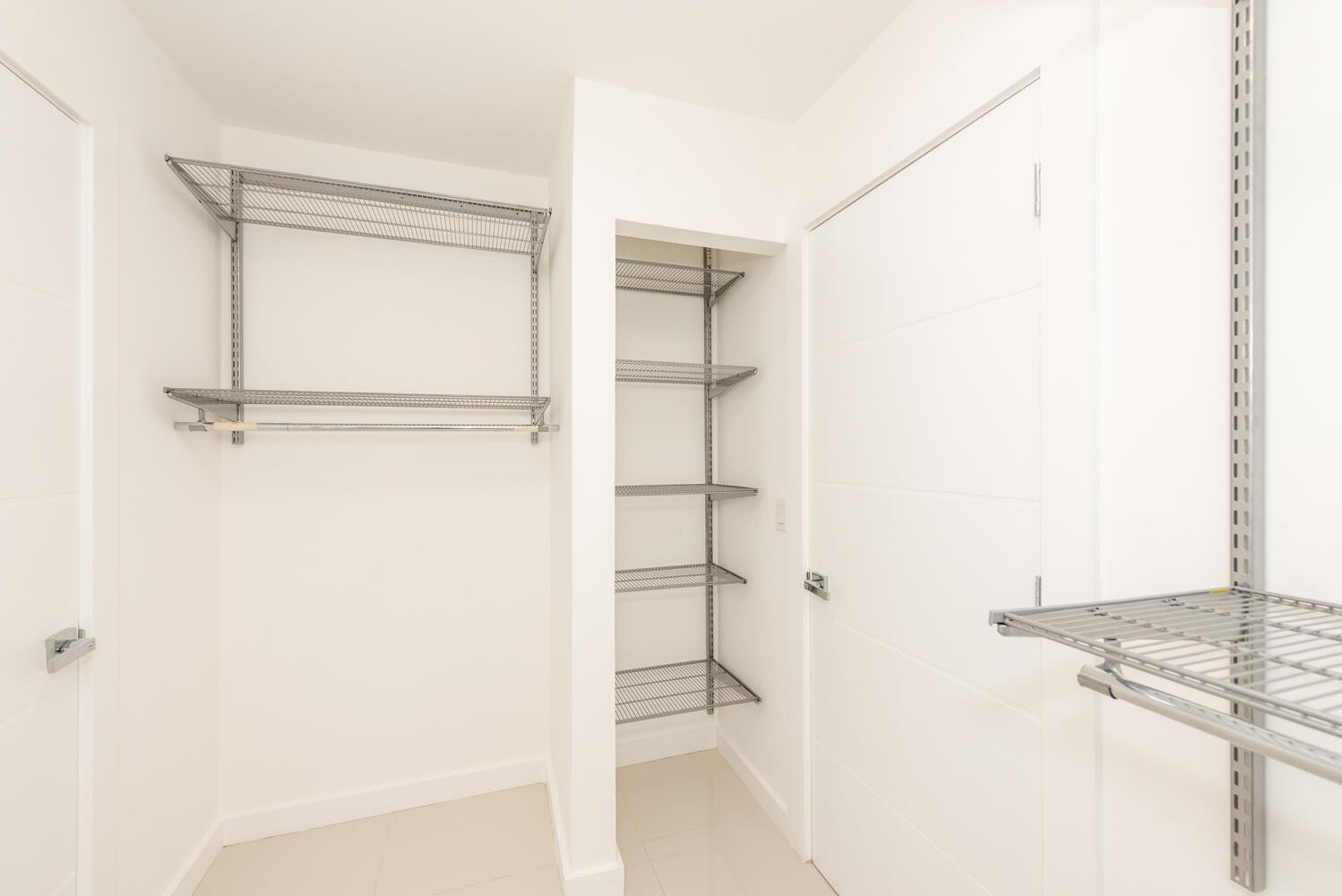 6604 Southwest 114th Place, Unit C72 Miami, FL 33173 - Photo 20 of 28 a view of walk in closet with empty racks