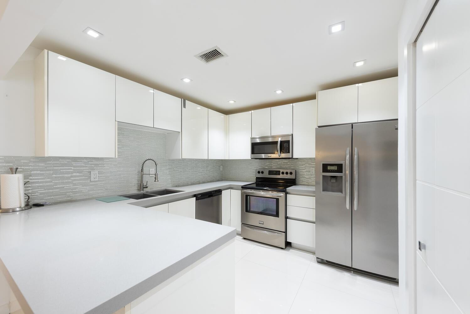 6604 Southwest 114th Place, Unit C72 Miami, FL 33173 - Photo 10 of 28 a kitchen with stainless steel appliances a refrigerator sink and microwave