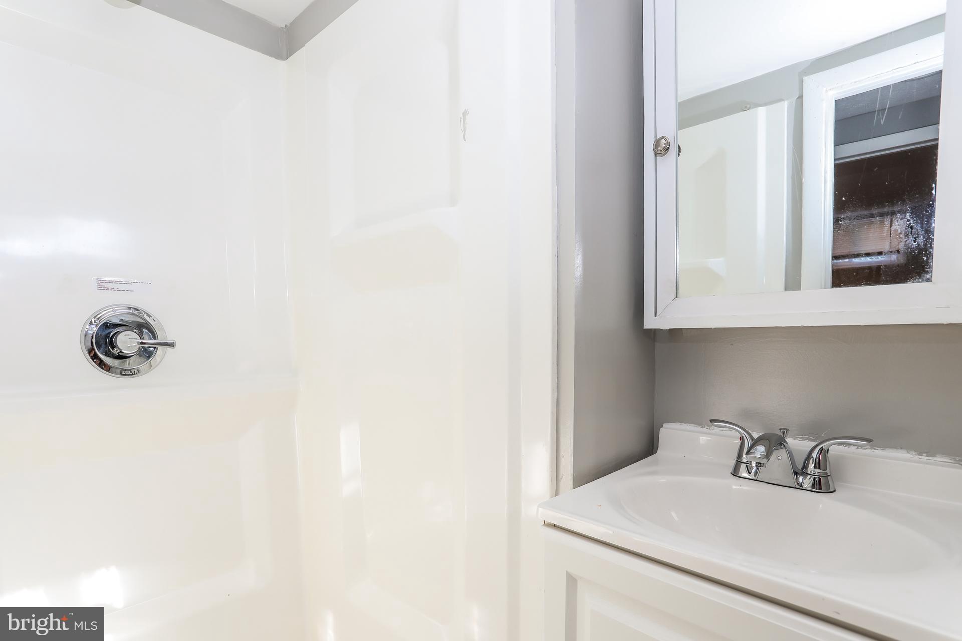 5911 Ayleshire Road Baltimore, MD 21239 - Photo 7 of 10 a bathroom with a sink and a vanity