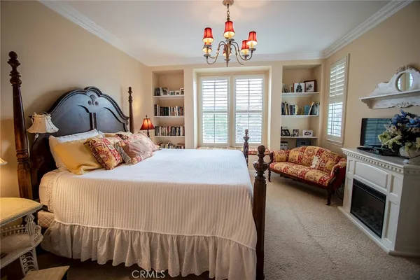 a bedroom with a bed next to a large window with the outer view