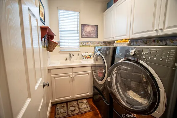a bathroom with a granite countertop sink mirror bathtub and double