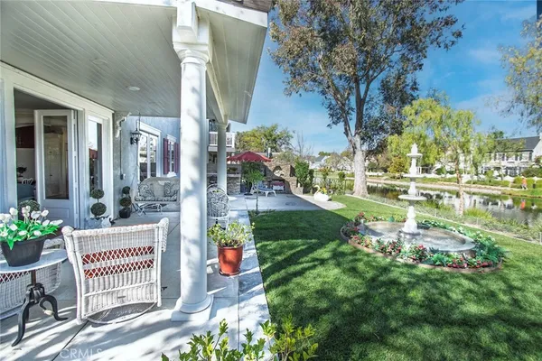 a living room with patio furniture and garden view