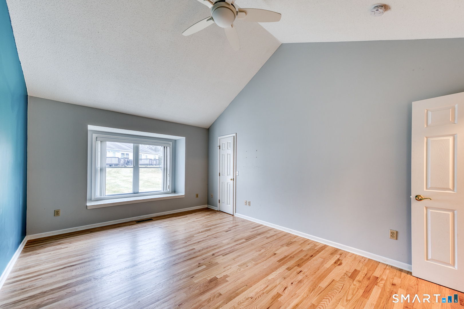 811 Village Road, Unit 811 Southington, CT 06489 - Photo 14 of 40 an empty room with wooden floor and windows