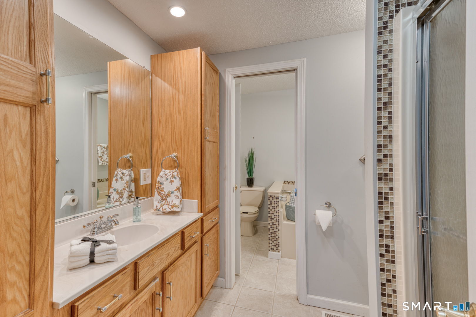 811 Village Road, Unit 811 Southington, CT 06489 - Photo 15 of 40 a bathroom with a double vanity sink mirror and toilet