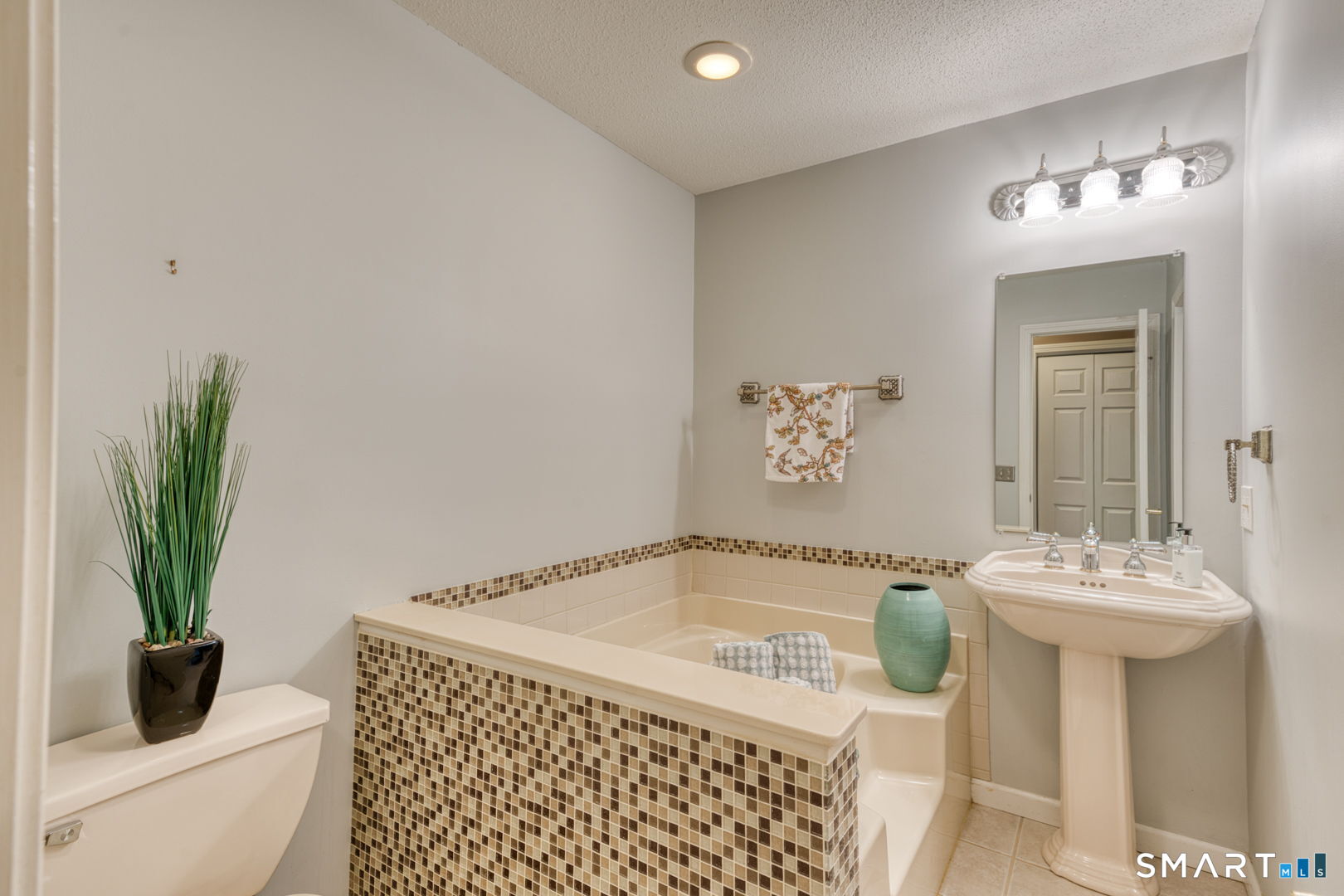 811 Village Road, Unit 811 Southington, CT 06489 - Photo 16 of 40 a bathroom with a sink a toilet and a mirror