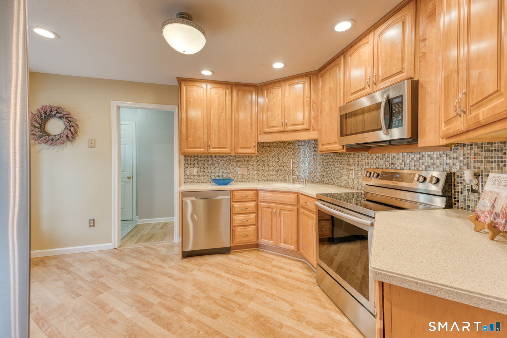 811 Village Road, Unit 811 Southington, CT 06489 - Photo 2 of 40 a kitchen with stainless steel appliances granite countertop a stove a sink and a refrigerator