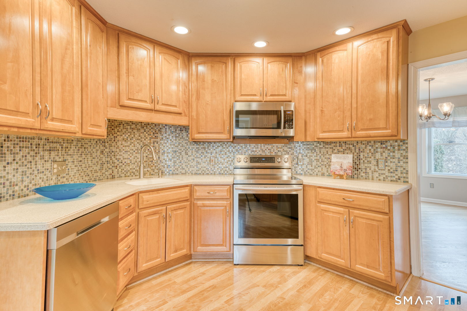 811 Village Road, Unit 811 Southington, CT 06489 - Photo 5 of 40 a kitchen with stainless steel appliances granite countertop a stove a sink and a microwave