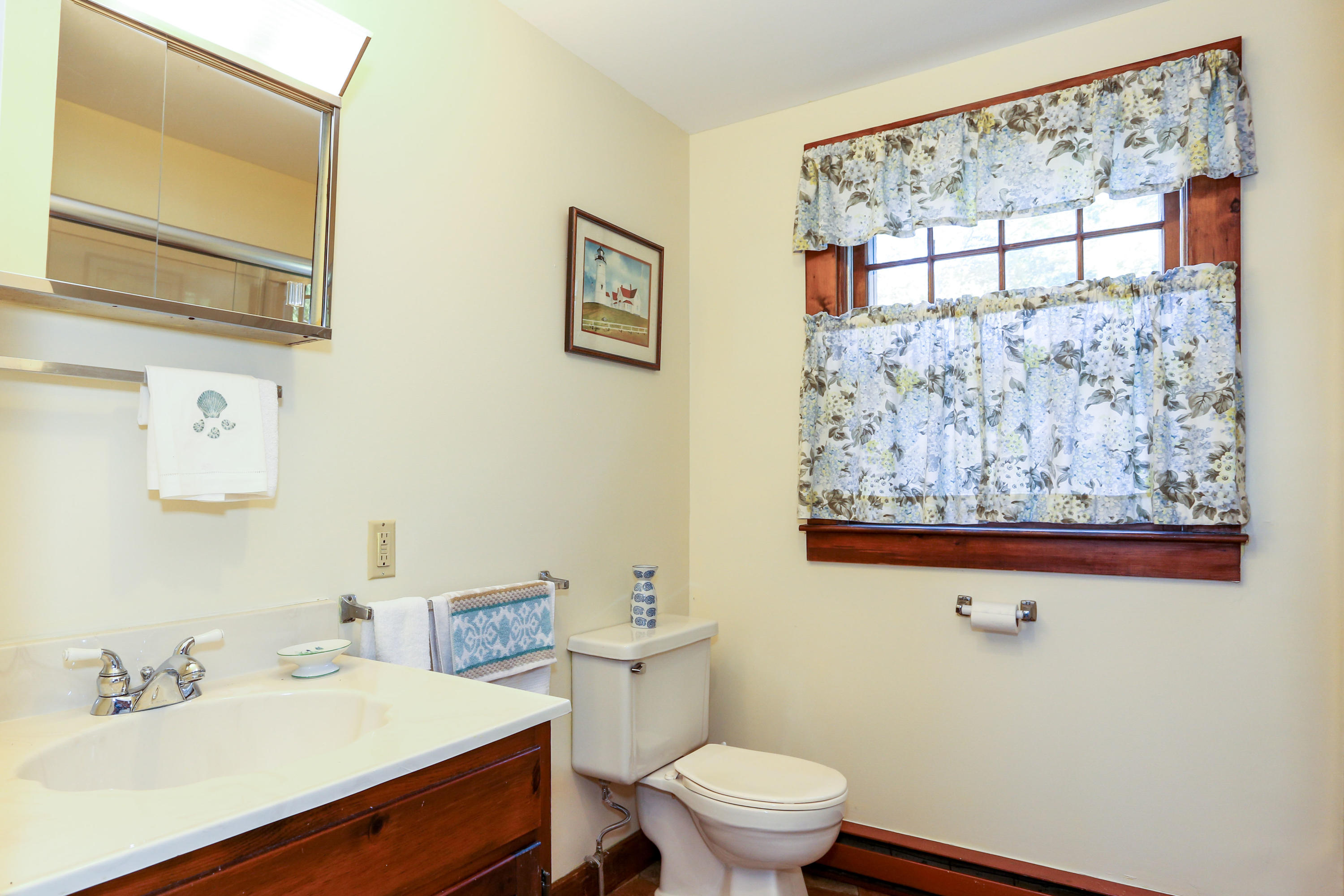 52 Gibson Road Orleans, MA 02653 - Photo 6 of 30 a bathroom with a sink mirror and a toilet