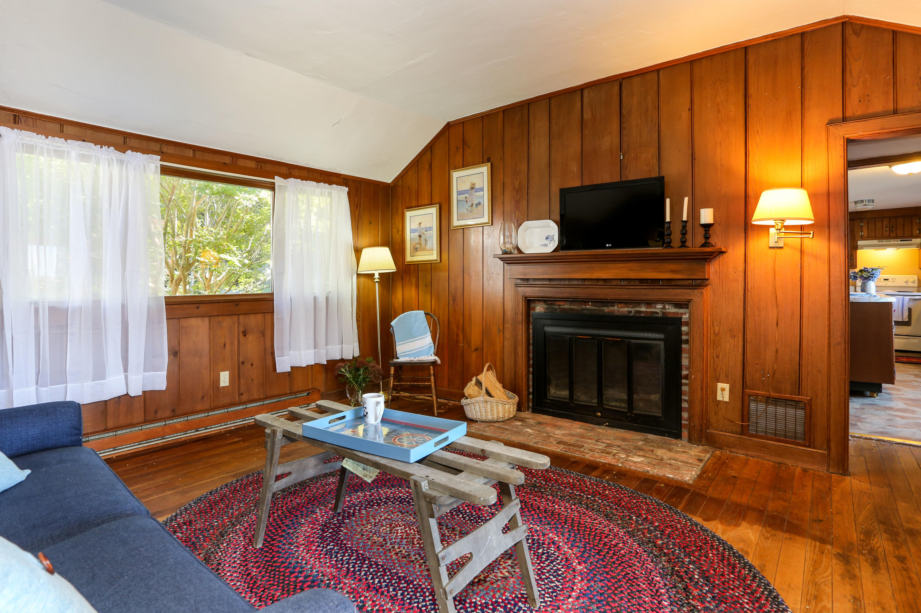 52 Gibson Road Orleans, MA 02653 - Photo 10 of 30 a living room with furniture a flat screen tv and a fireplace