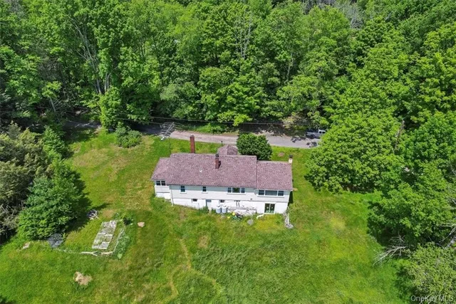 aerial view of a house with a yard