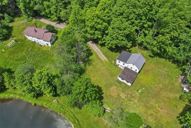an aerial view of a house with a yard