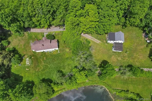 an aerial view of a house with a yard