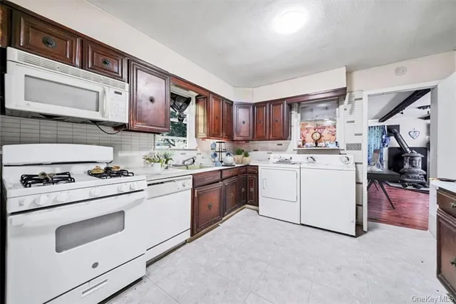 a kitchen with a stove top oven sink and cabinets