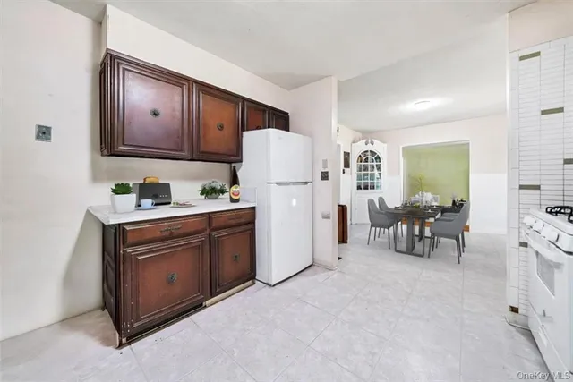 a kitchen with furniture and a refrigerator