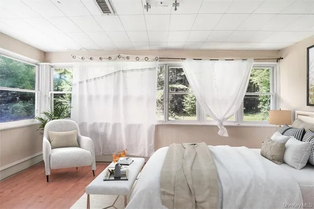 a bedroom with furniture and a large window