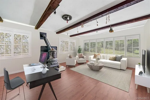 a living room with furniture and floor to ceiling window