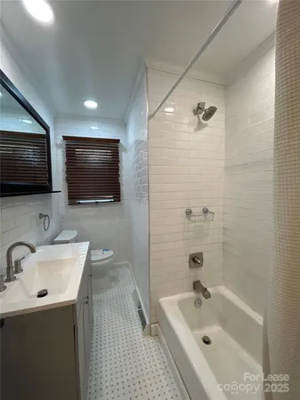 a bathroom with a sink a mirror and a bathtub