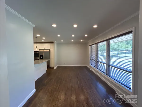 a view of empty room with wooden floor and fireplace