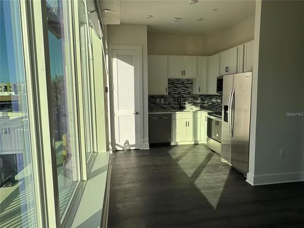 a kitchen with stainless steel appliances a refrigerator sink and microwave
