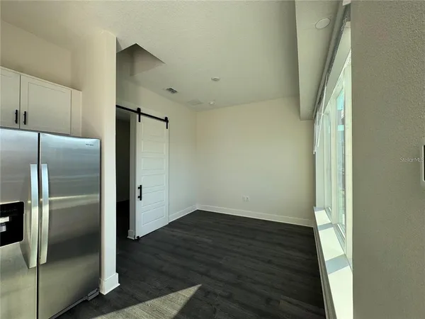 a kitchen with a sink and steel appliances