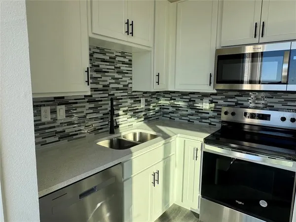 a kitchen with a stove microwave and refrigerator