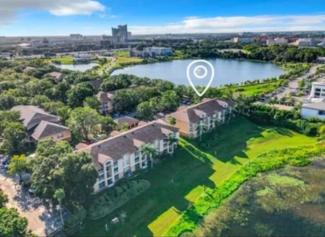 an aerial view of a city with lots of residential buildings lake and ocean view