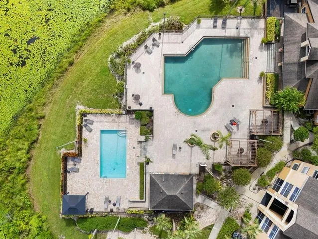 an aerial view of a house with outdoor space and lake view