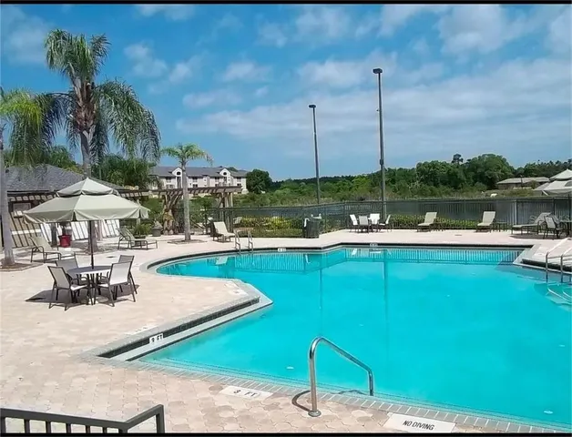 a view of a lake with a table and chairs