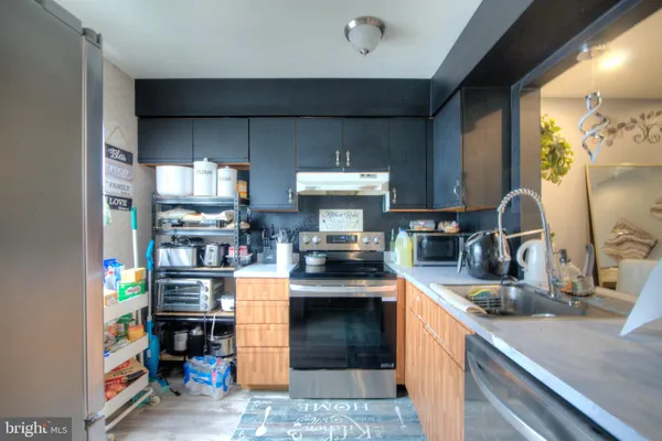 a kitchen with stainless steel appliances granite countertop a stove and a refrigerator