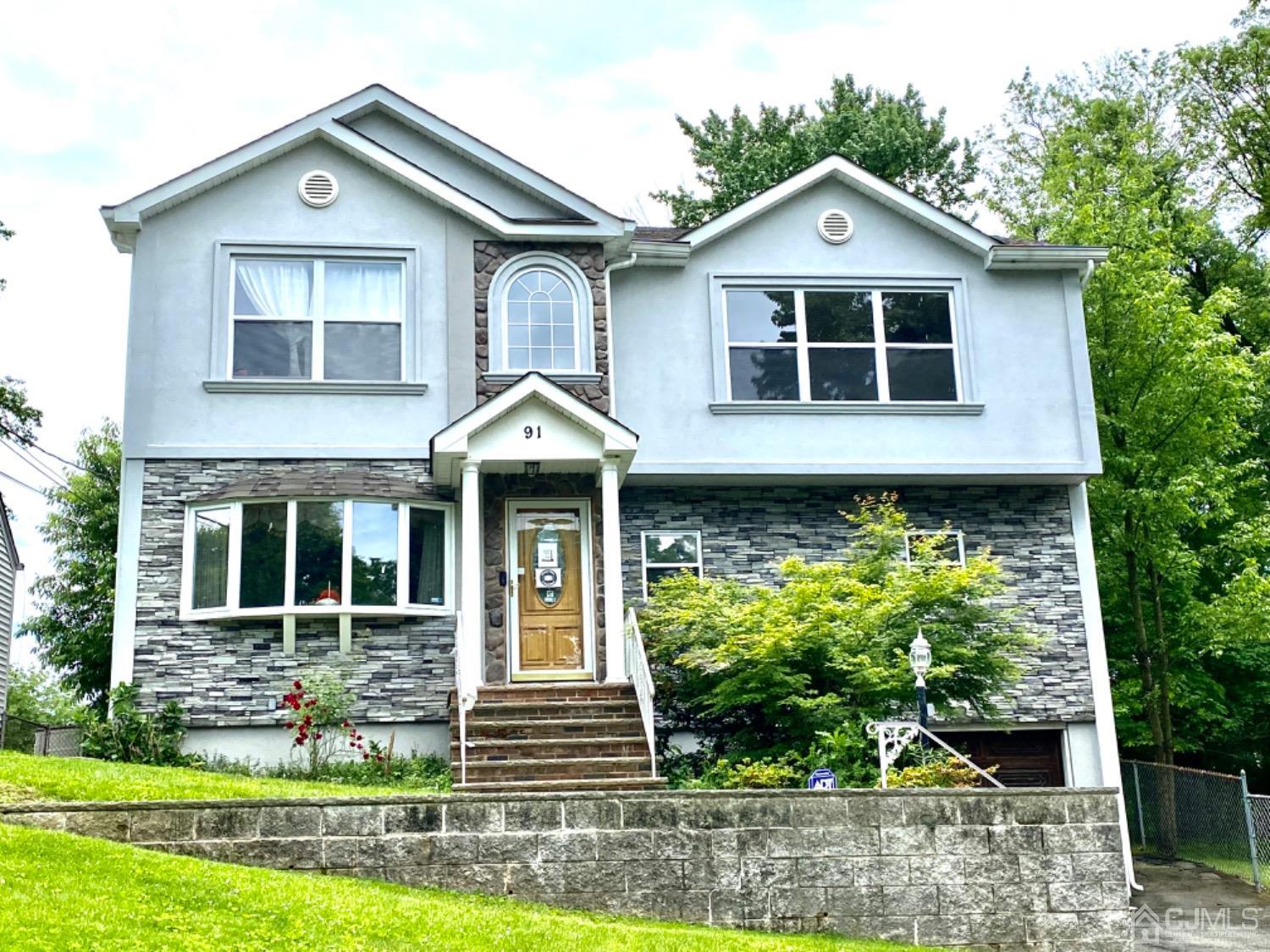 91 Holly Road Iselin, NJ 08830 - Photo 1 of 25 a front view of a house with a yard
