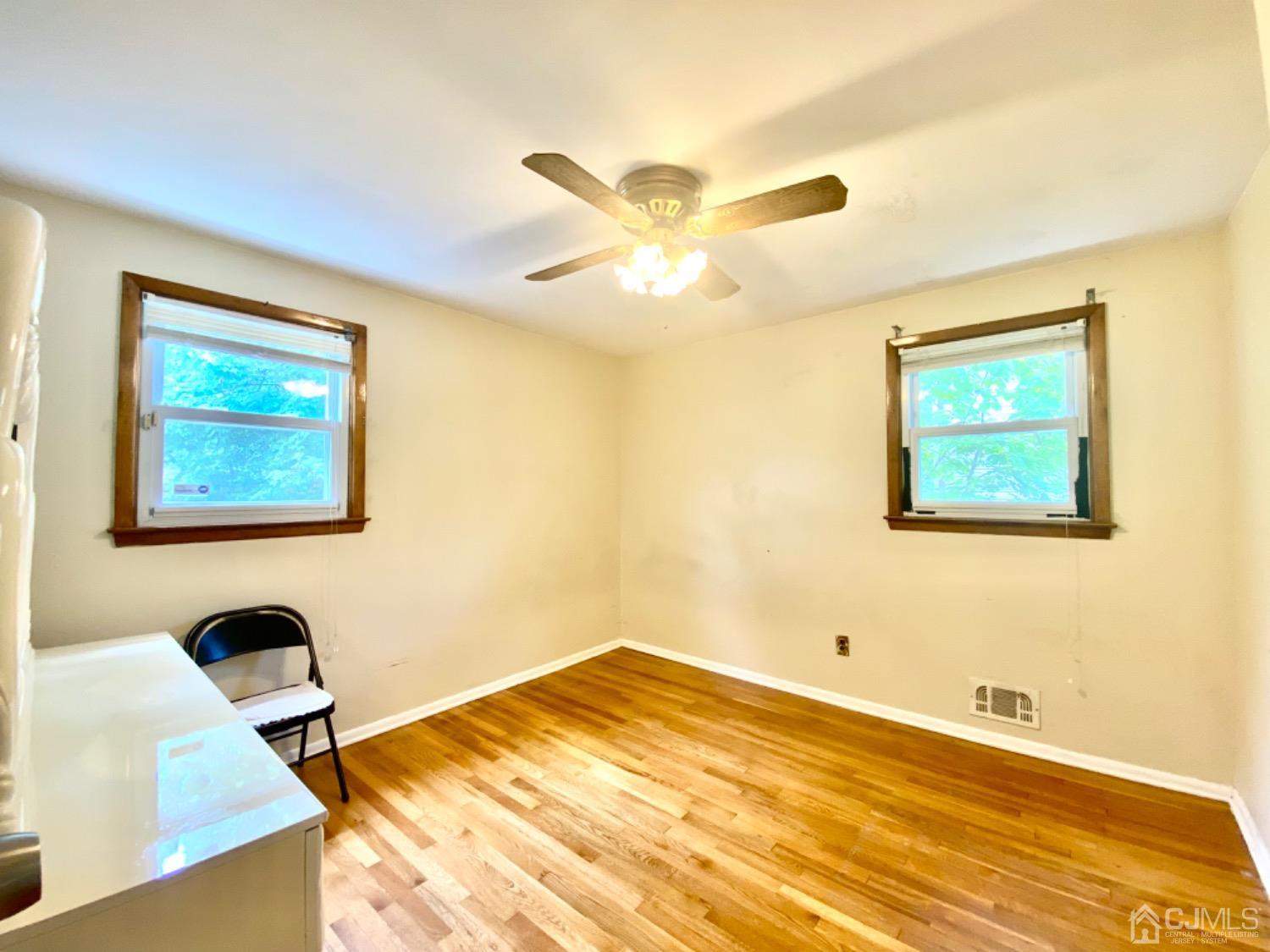 91 Holly Road Iselin, NJ 08830 - Photo 12 of 25 a bedroom with a bed and a desk
