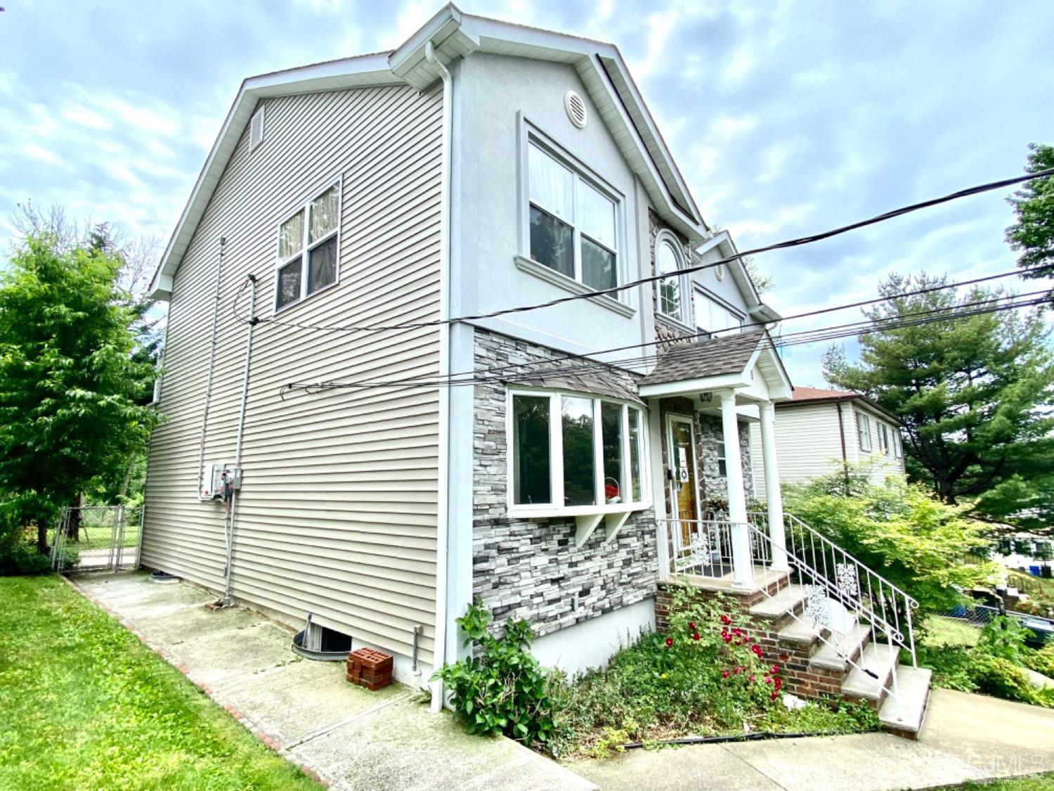 91 Holly Road Iselin, NJ 08830 - Photo 2 of 25 a front view of a house with garden