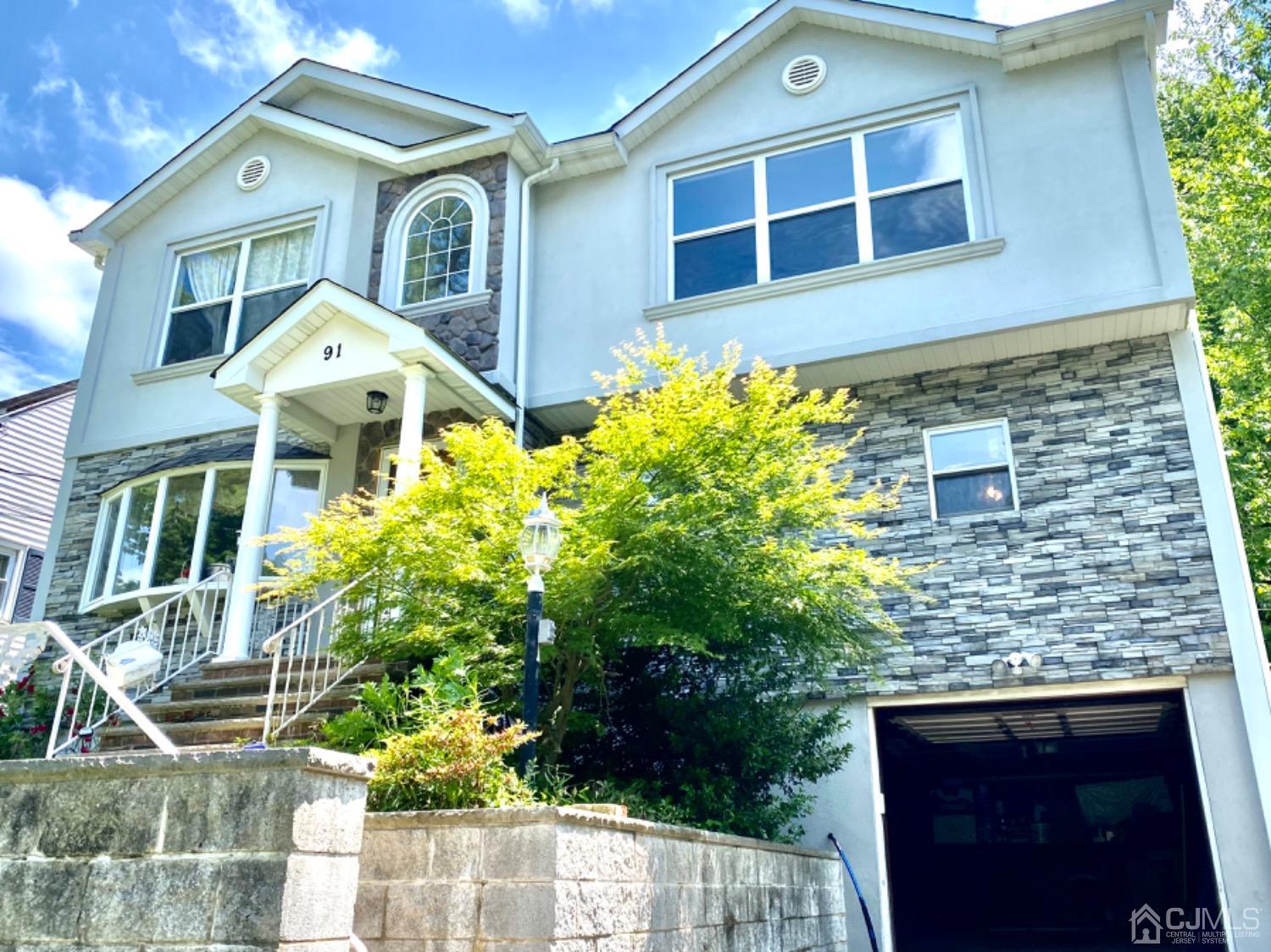91 Holly Road Iselin, NJ 08830 - Photo 24 of 25 a front view of a house with a yard